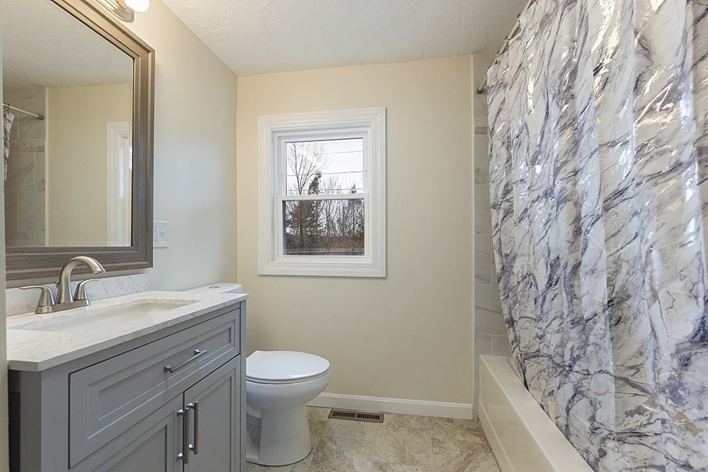 32 Elaine Street Webster, MA 01570 - Photo 24 of 42 a bathroom with a granite countertop toilet sink and mirror