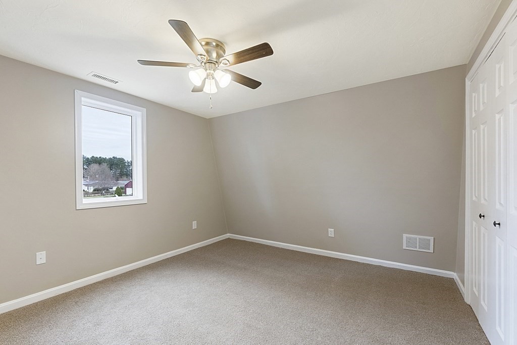 32 Elaine Street Webster, MA 01570 - Photo 25 of 42 an empty room with a window and a fan
