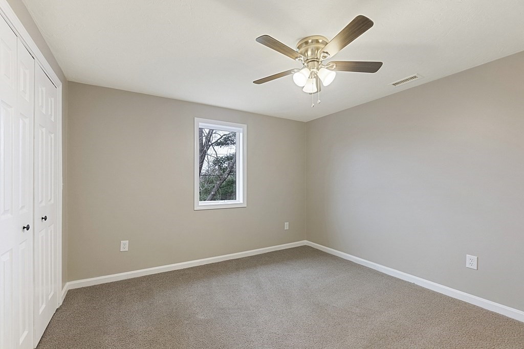 32 Elaine Street Webster, MA 01570 - Photo 29 of 42 an empty room with a window and a fan
