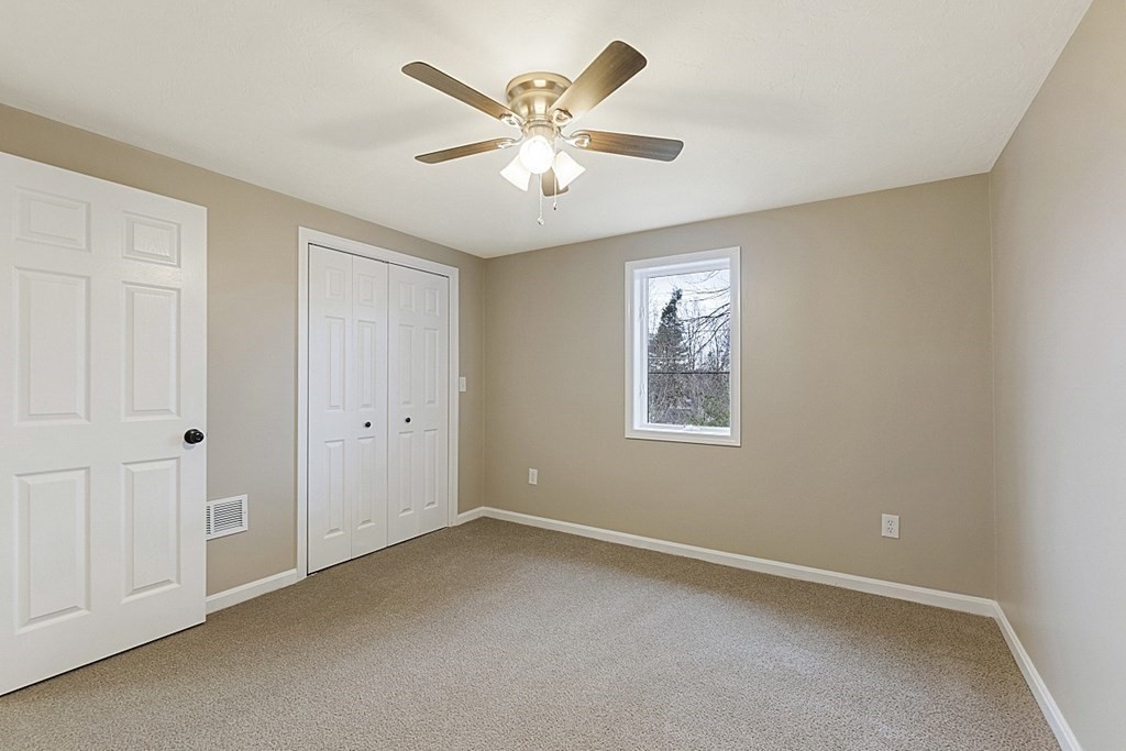 32 Elaine Street Webster, MA 01570 - Photo 31 of 42 an empty room with windows and ceiling fan