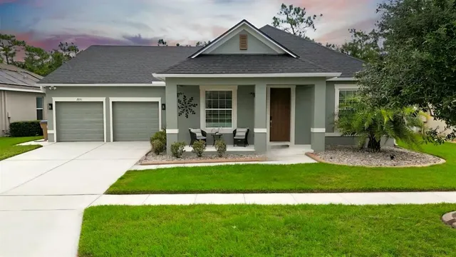 a view of multiple houses with yard and green space