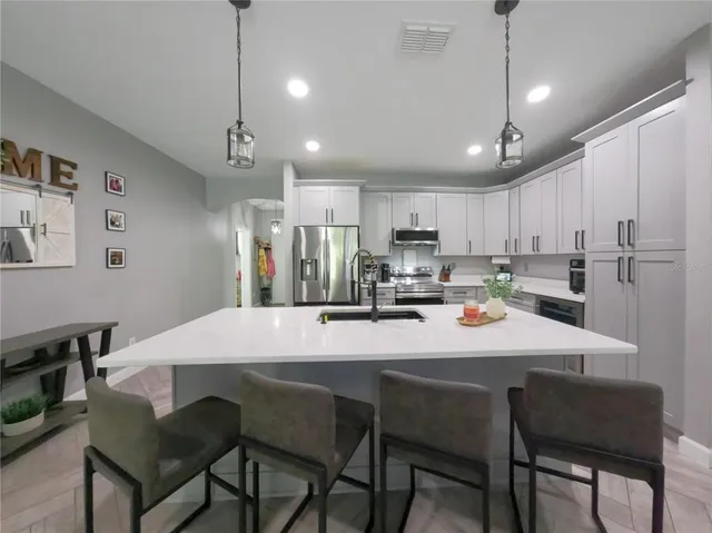 a living room with furniture a flat screen tv and a large window