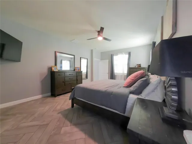 a bed room with a bed window and a television