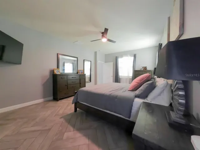 a spacious bathroom with a sink a toilet and a mirror