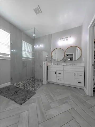 a bedroom with a bed and a refrigerator