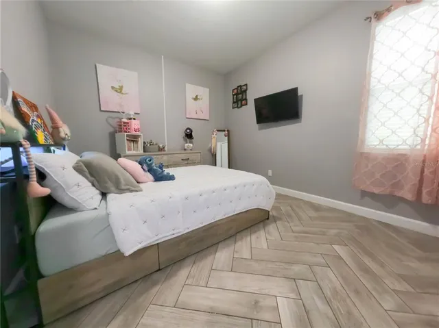 a bedroom with a bed and a tv in it