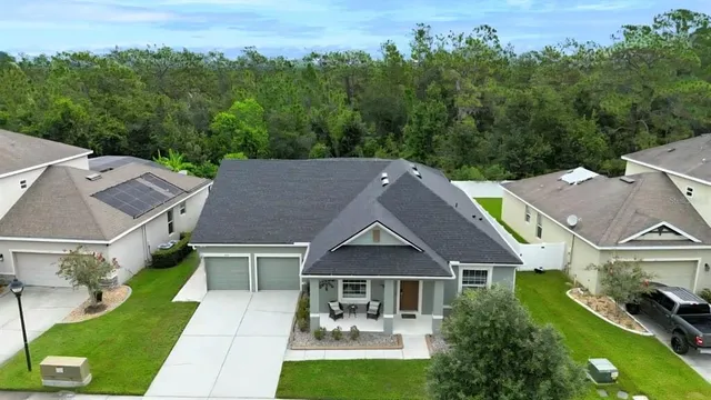 an aerial view of a house with a yard and stairs