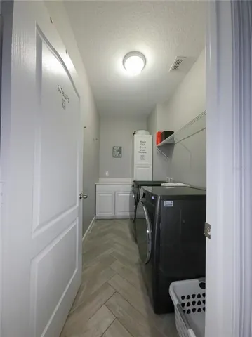 a view of a backyard with table and chairs under an umbrella