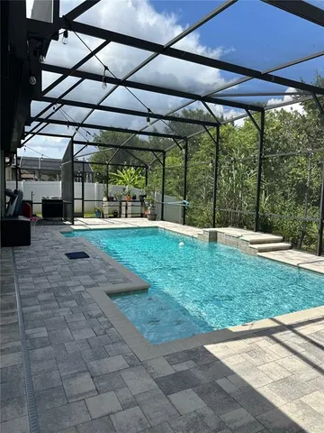 a view of a backyard with table and chairs under an umbrella