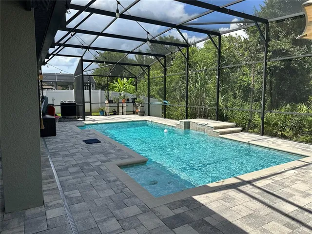 a view of a porch with furniture and a yard