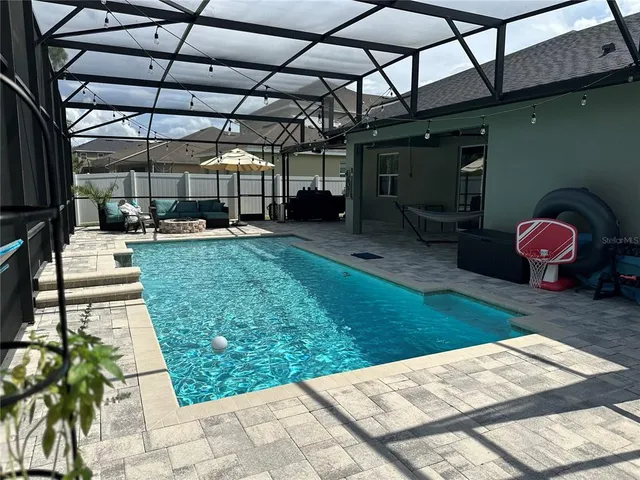 a view of backyard with a patio