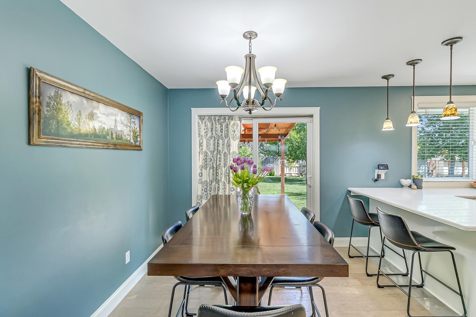 2118 Saguaro Road Grand Junction, CO 81507 - Photo 9 of 42 a view of a dining room with furniture a chandelier and wooden floor