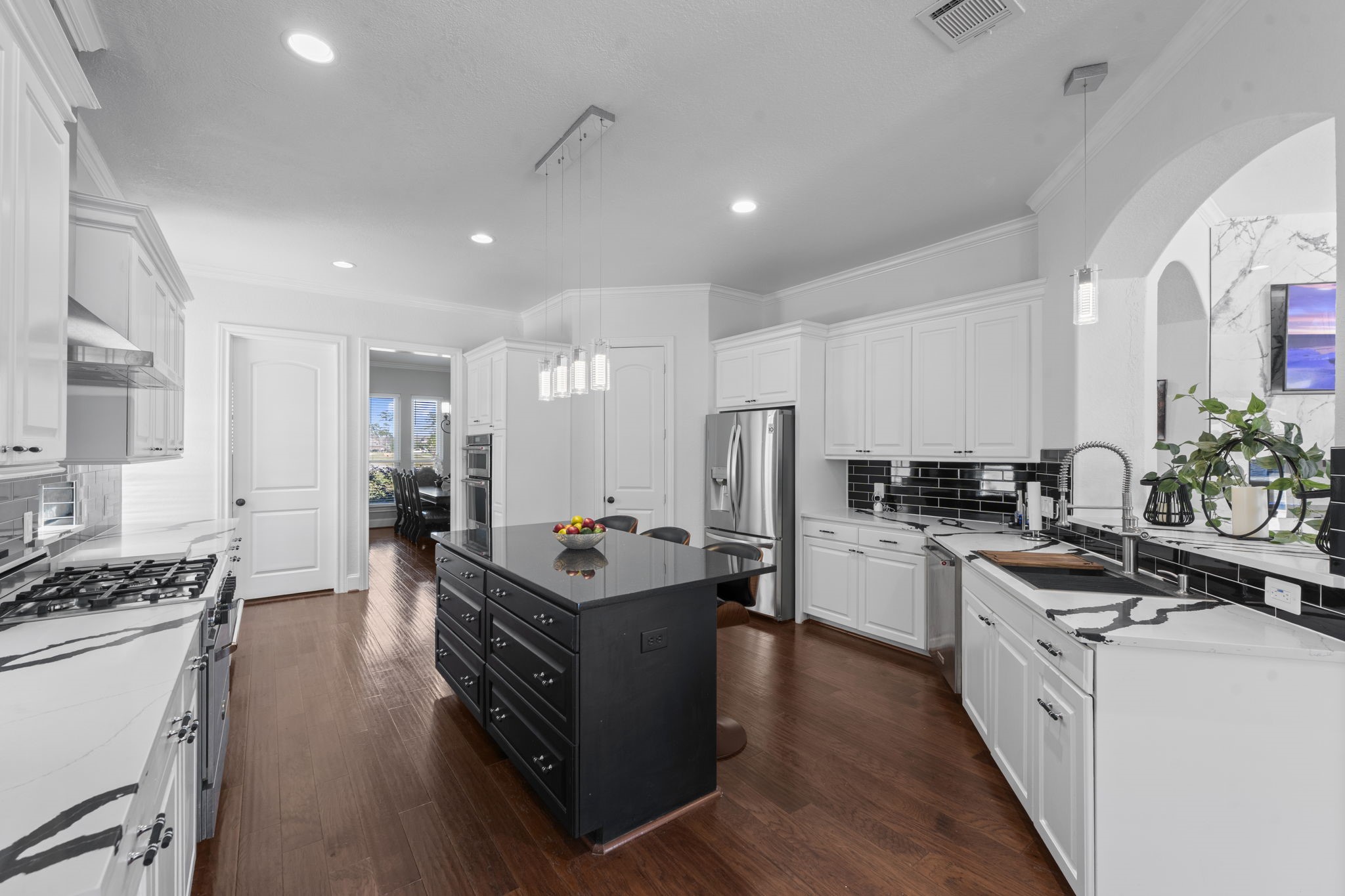 4430 Chateau Creek Way Spring, TX 77386 - Photo 11 of 46 a kitchen with refrigerator a stove and cabinets