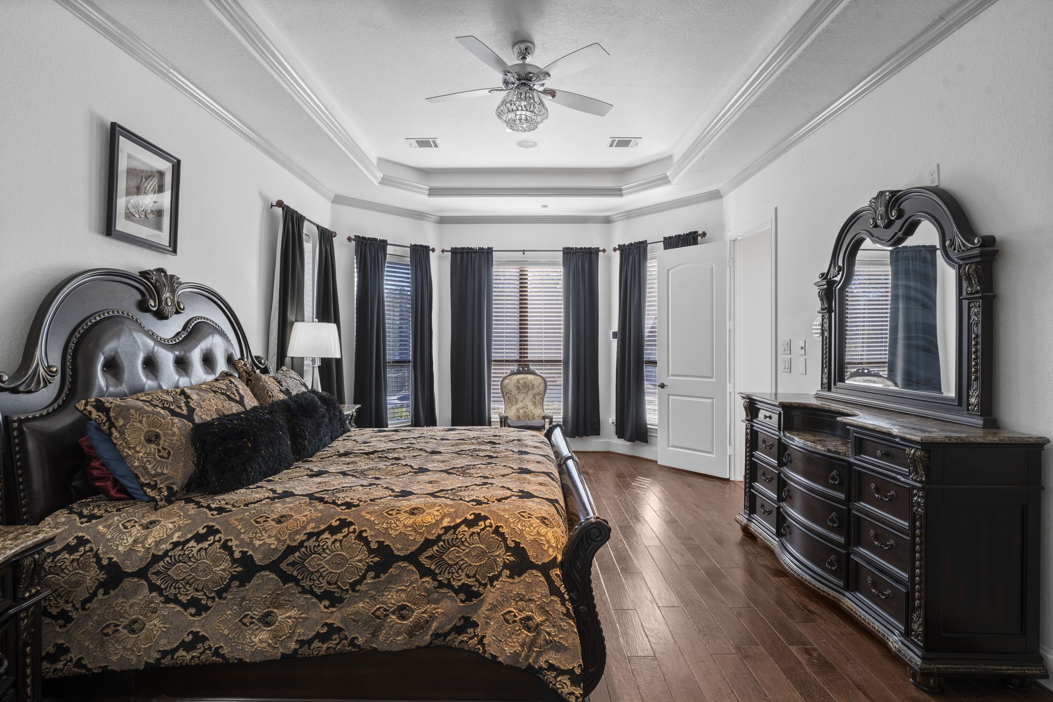 4430 Chateau Creek Way Spring, TX 77386 - Photo 15 of 46 a bedroom with a bed a dresser with mirror