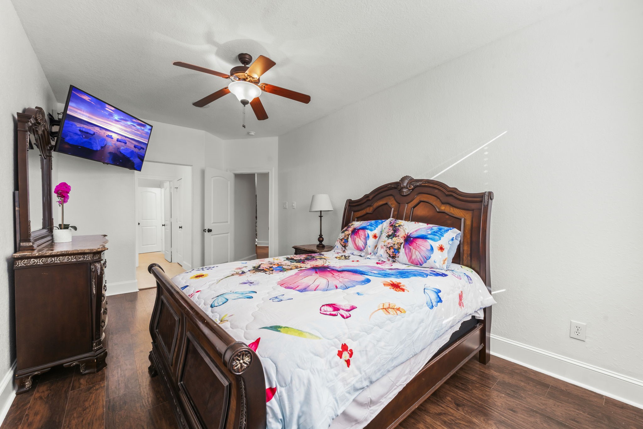 4430 Chateau Creek Way Spring, TX 77386 - Photo 24 of 46 a bedroom with a bed and wooden floor