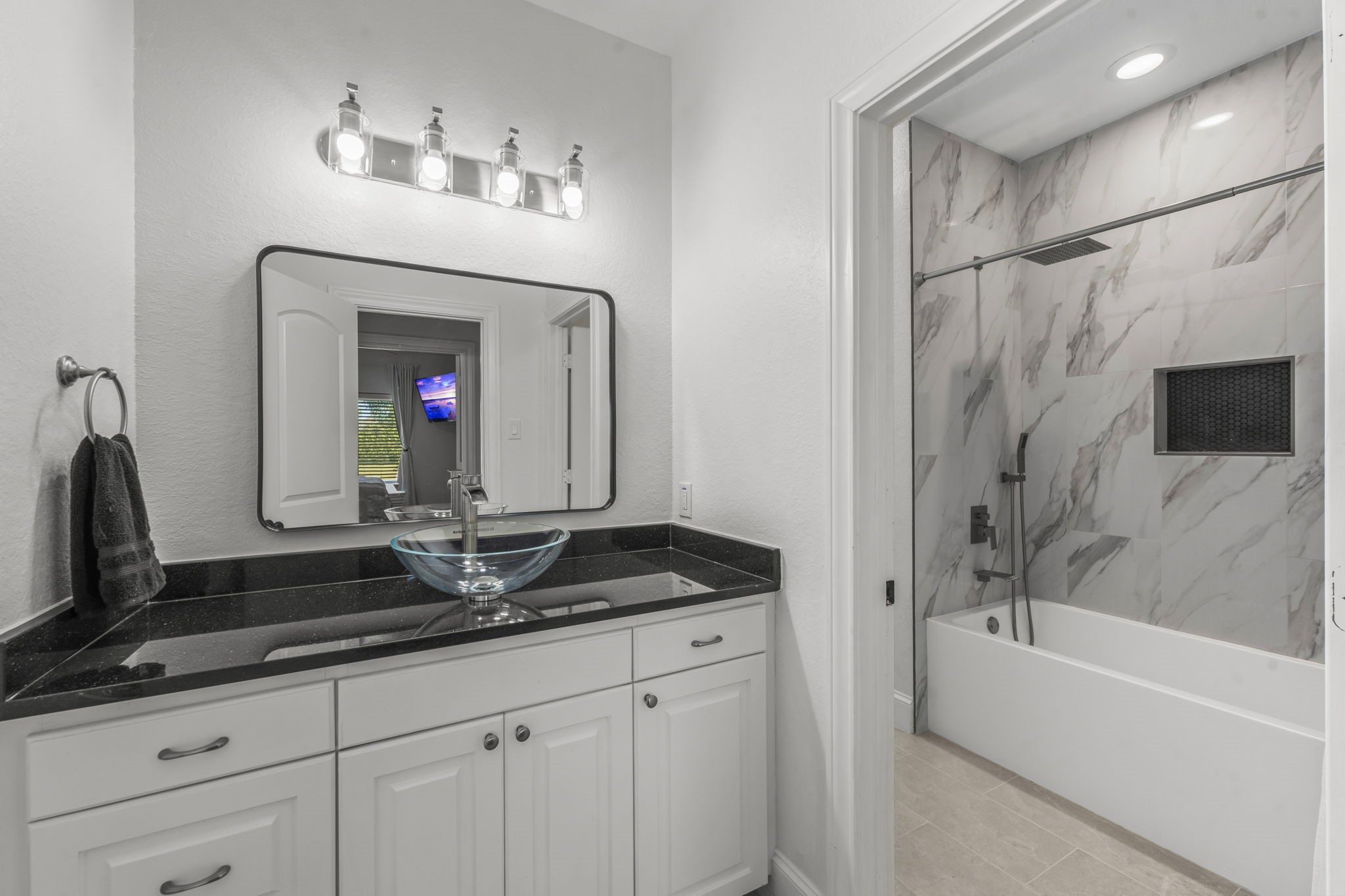 4430 Chateau Creek Way Spring, TX 77386 - Photo 28 of 46 a bathroom with a double vanity sink a mirror and a bathtub