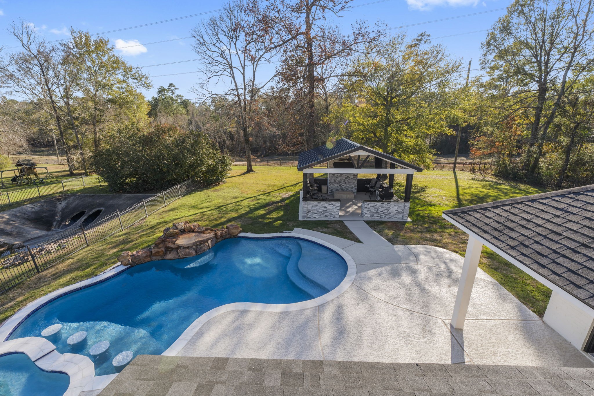 4430 Chateau Creek Way Spring, TX 77386 - Photo 43 of 46 a view of a swimming pool with a patio