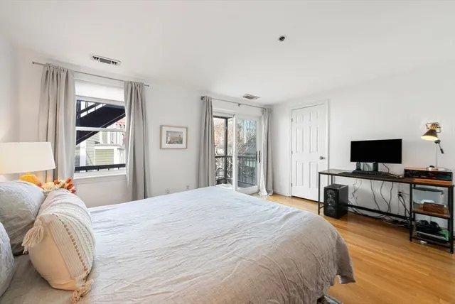 a bedroom with bed and flat screen tv