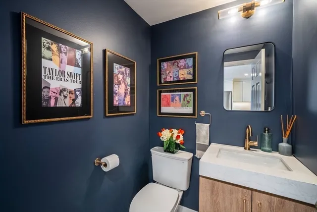 a bathroom with a toilet a sink and mirror