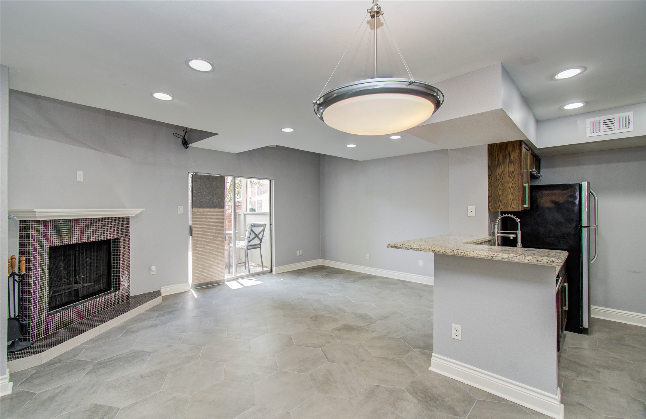 a view of a kitchen with a sink and a fireplace