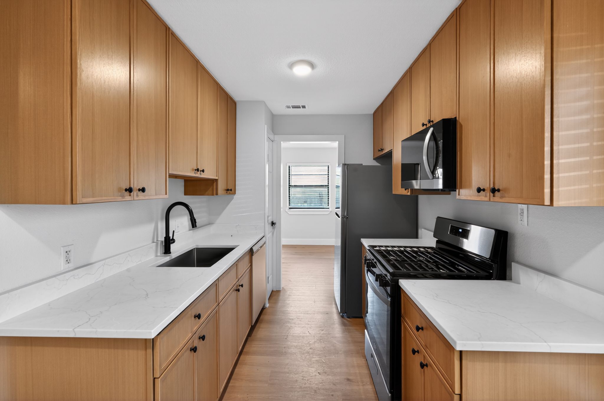 a kitchen that has a sink and a stove in it