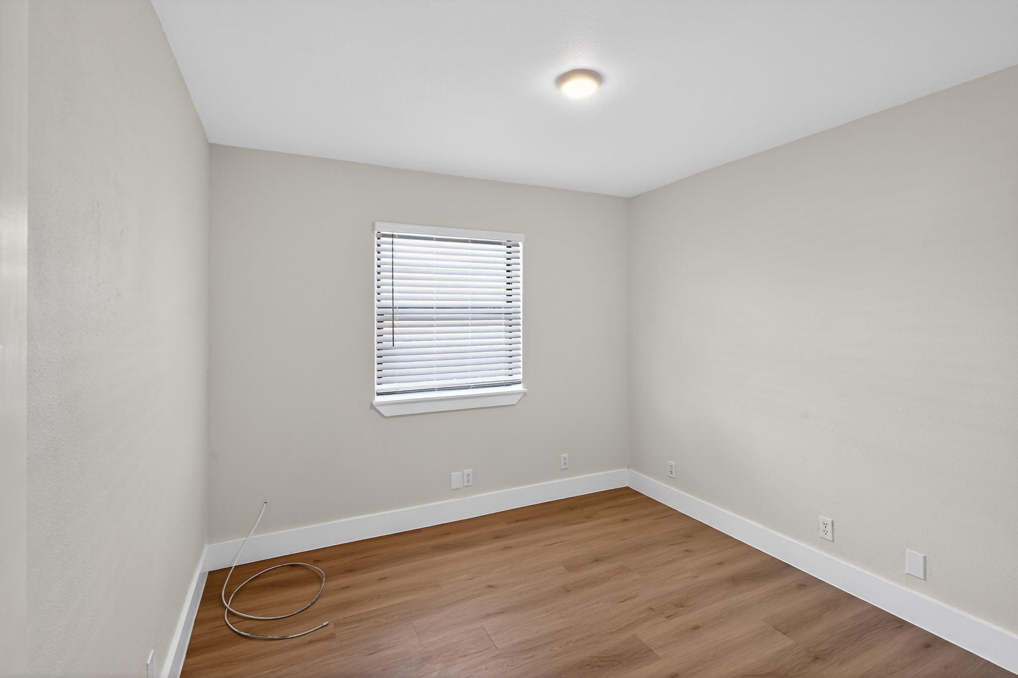 5928 Signal Point Austin, TX 78724 - Photo 13 of 14 an empty room with wooden floor and windows