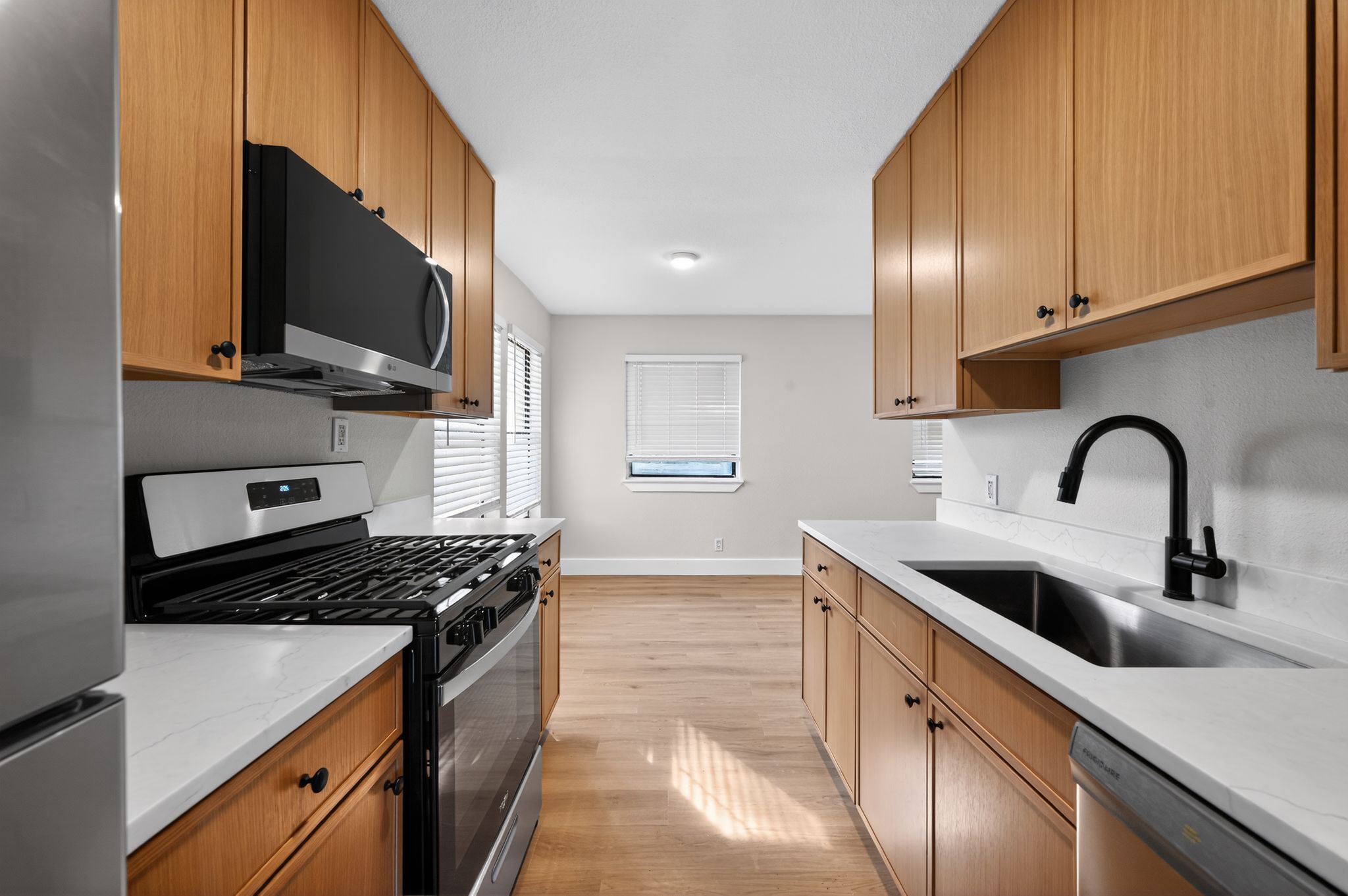 5928 Signal Point Austin, TX 78724 - Photo 2 of 14 a kitchen with stainless steel appliances a sink a stove and a microwave