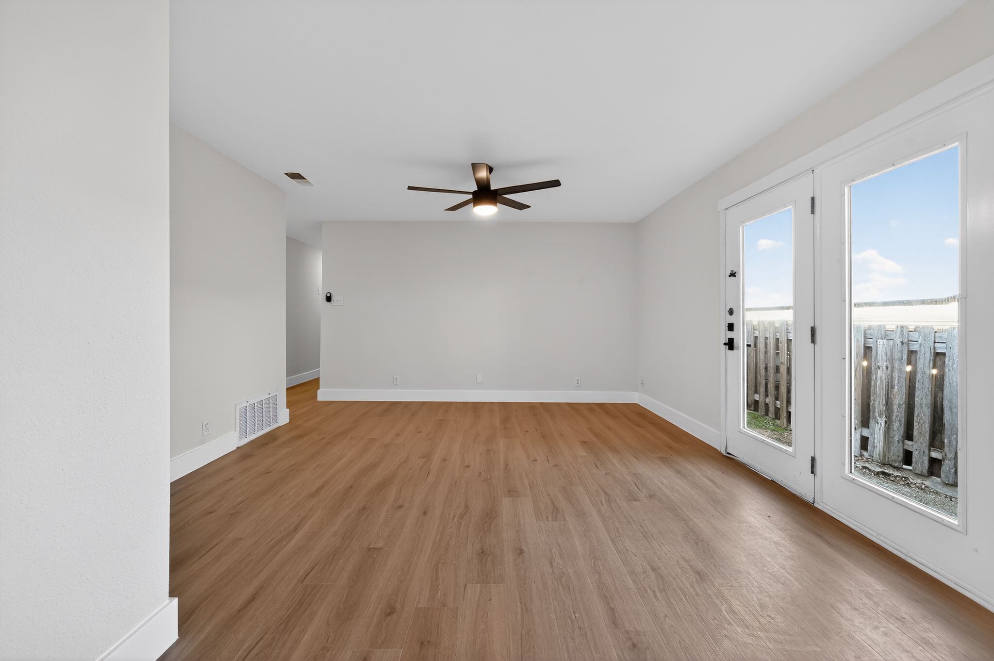 5928 Signal Point Austin, TX 78724 - Photo 7 of 14 wooden floor in an empty room with a window