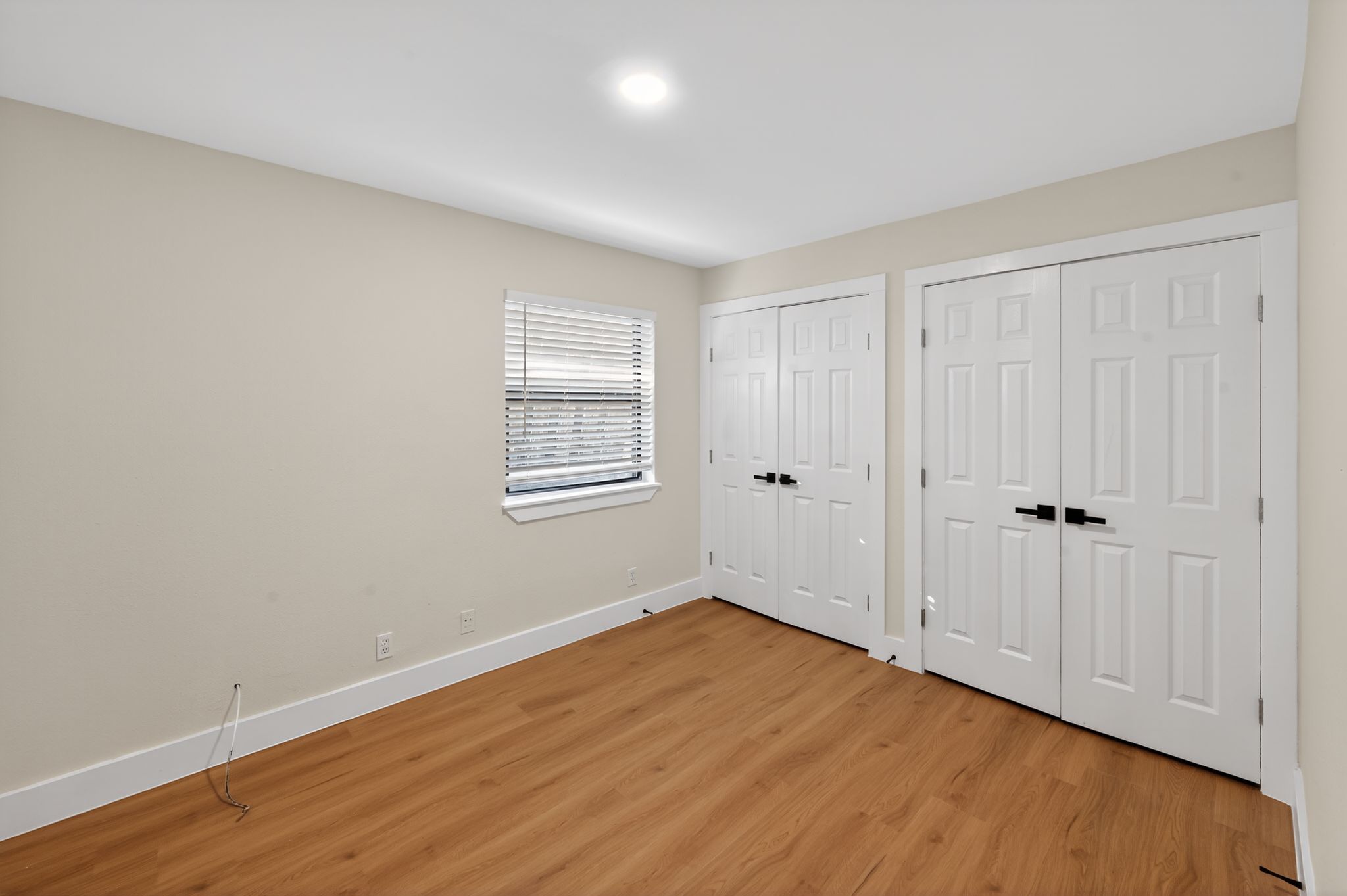 5928 Signal Point Austin, TX 78724 - Photo 9 of 14 a view of an empty room with wooden floor and a window