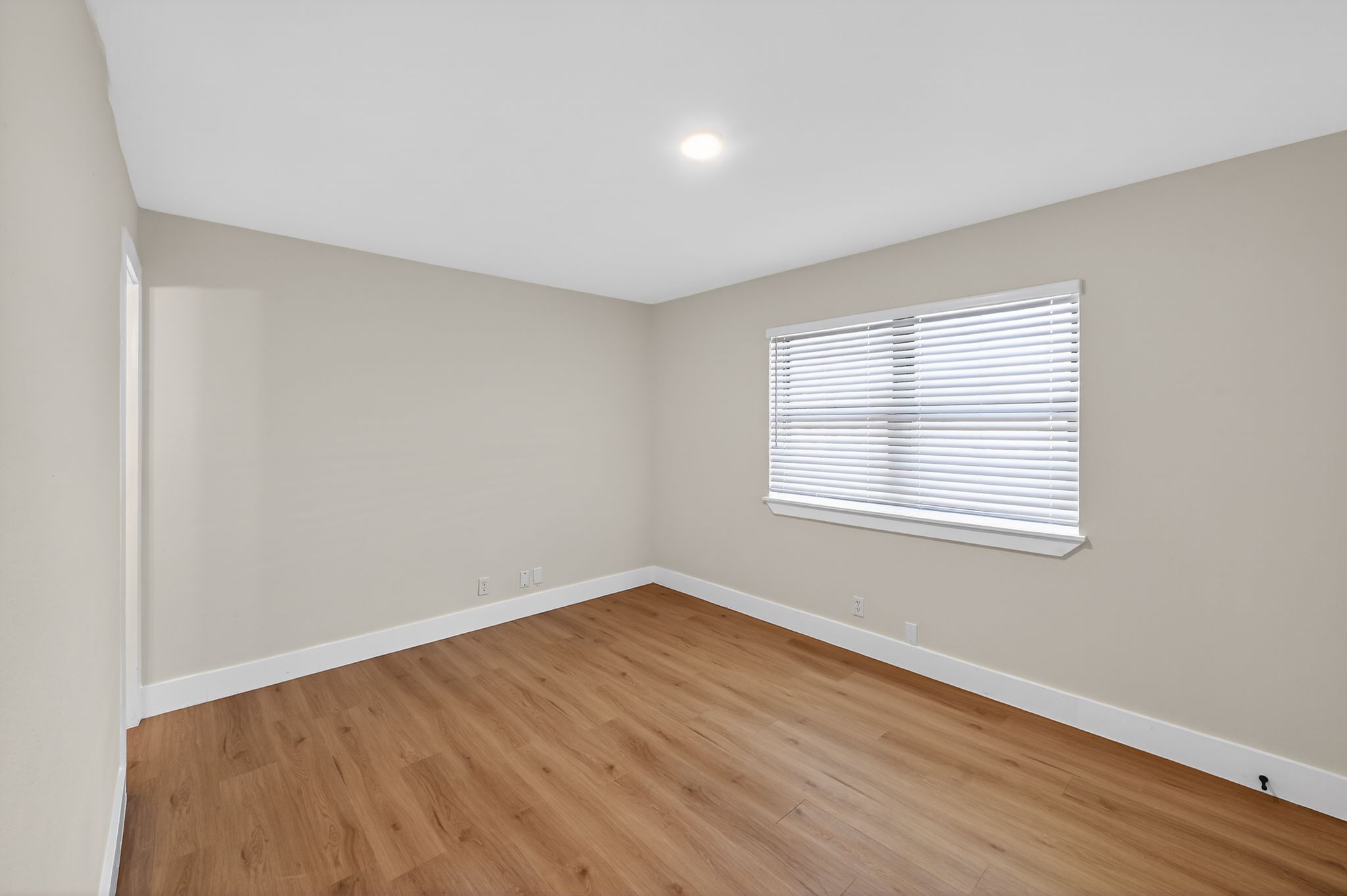 5928 Signal Point Austin, TX 78724 - Photo 10 of 14 a view of an empty room with wooden floor and a window