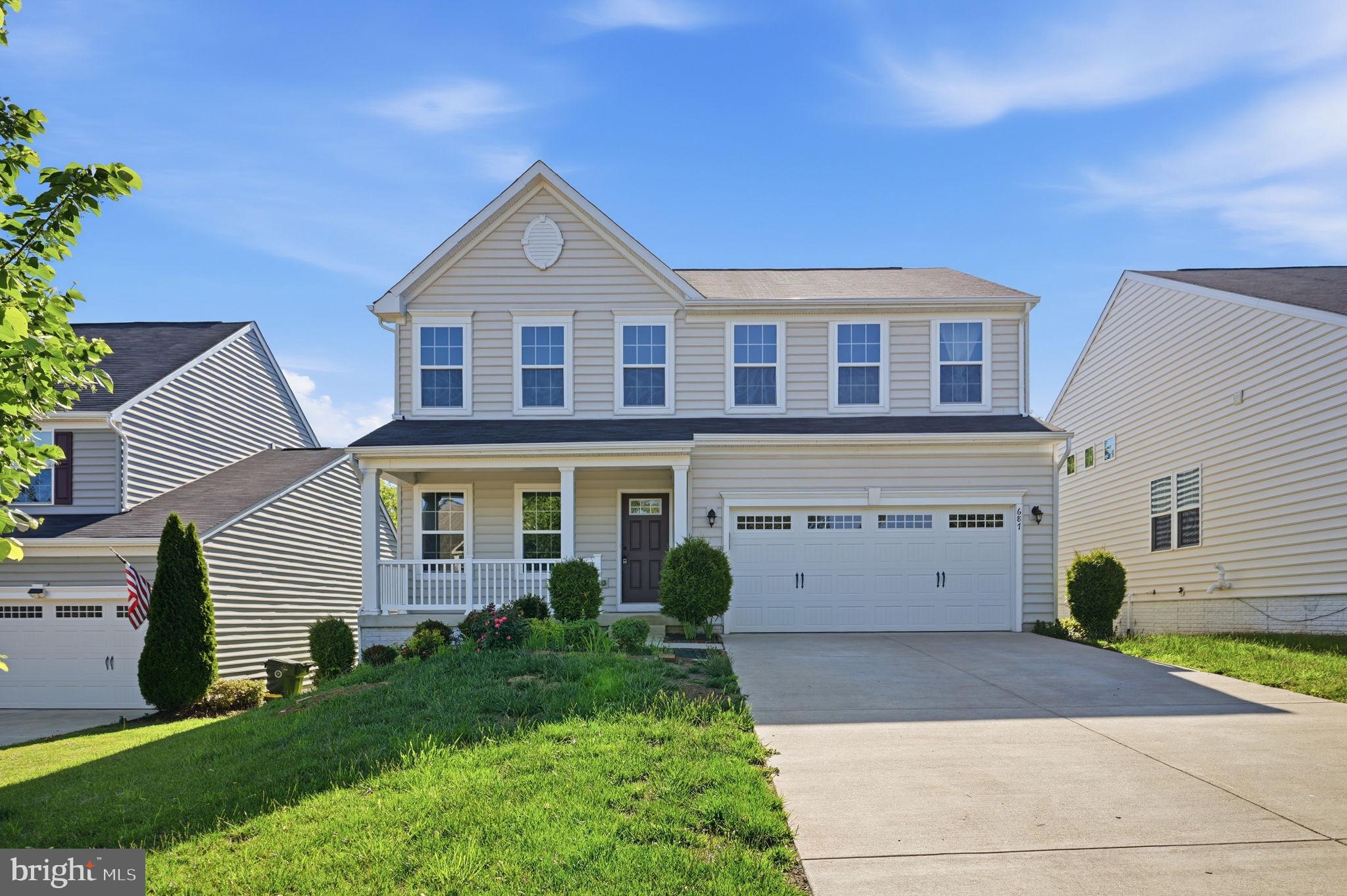 687 Blossom Tree Road Culpeper, VA 22701 - Photo 2 of 31 a front view of a house with a yard and garage