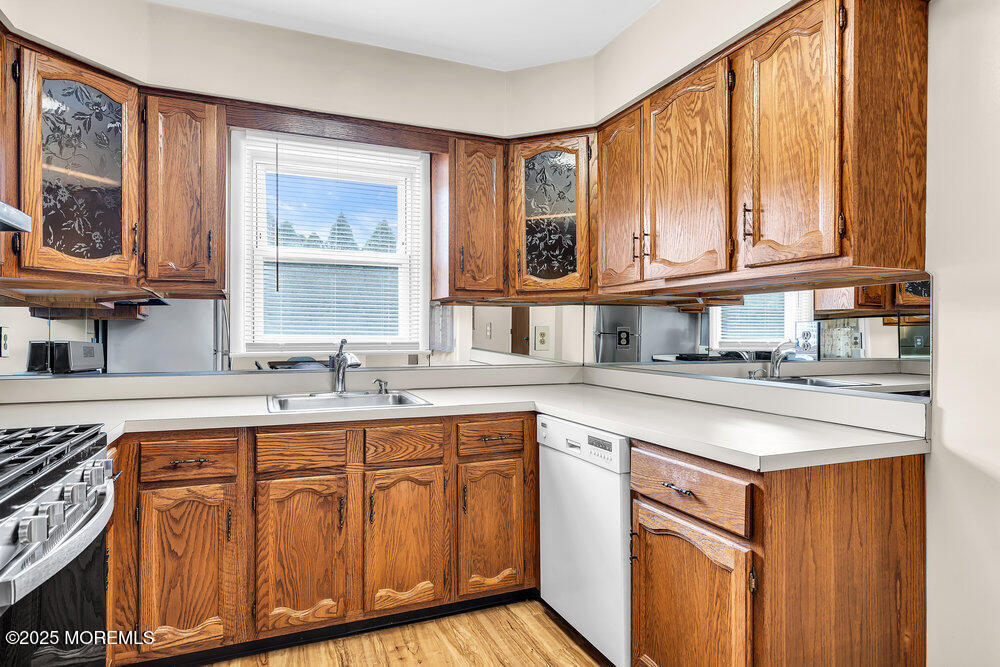 50 Oakfield Road Toms River, NJ 08757 - Photo 19 of 33 a kitchen with stainless steel appliances granite countertop a sink and cabinets with wooden floor