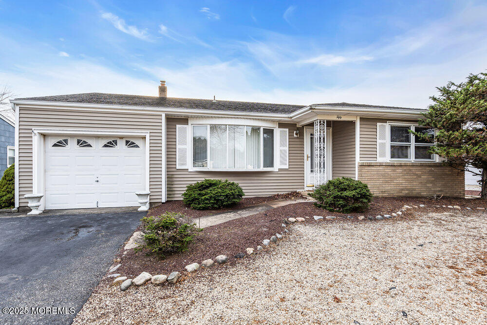 50 Oakfield Road Toms River, NJ 08757 - Photo 2 of 33 a front view of a house with a yard and garage
