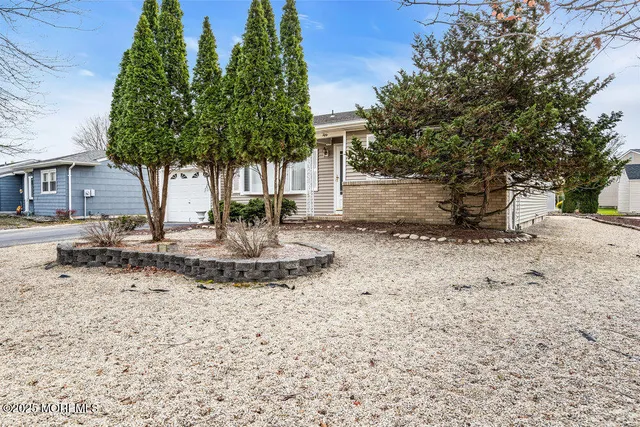 a view of a tree in front of a house