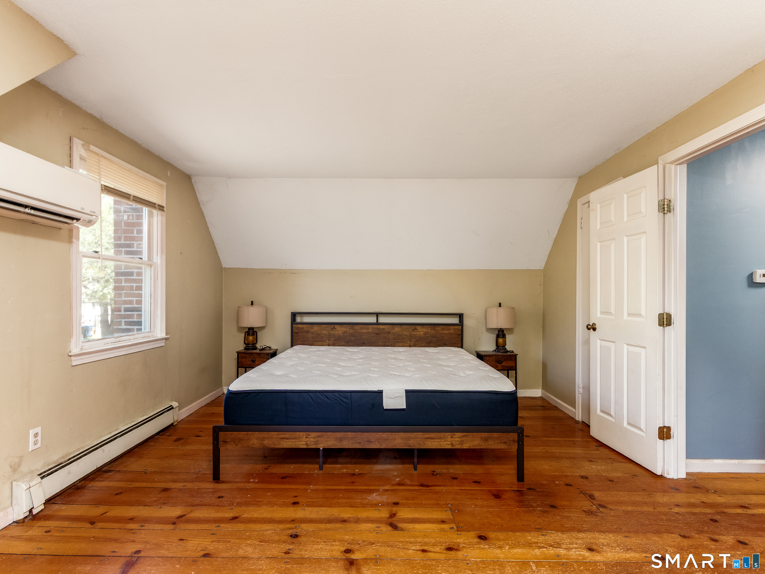 15 Bluff Avenue Clinton, CT 06413 - Photo 20 of 38 a bedroom with a bed and wooden floor