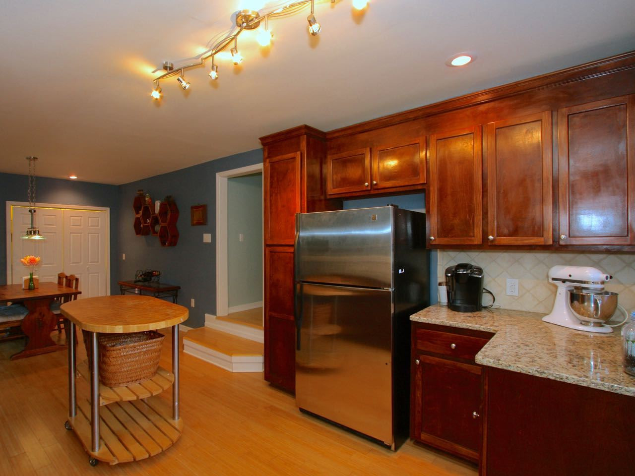 The kitchen has granite counters and stainless steel appliances. Kitchen