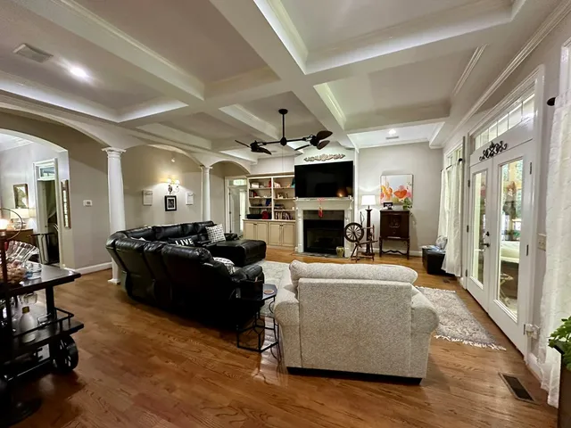 a bedroom with a bed and a mirror on a dresser