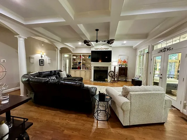 a living room with a bed furniture and a window