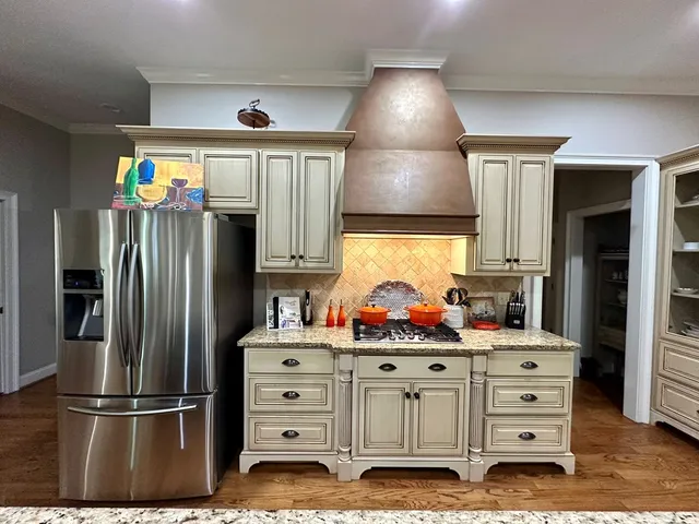 a bathroom with a granite countertop sink mirror vanity and toilet