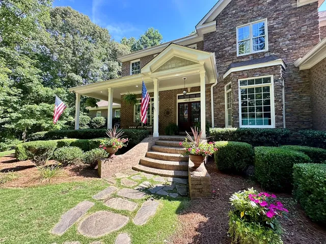 a front view of a house with a yard table and chairs