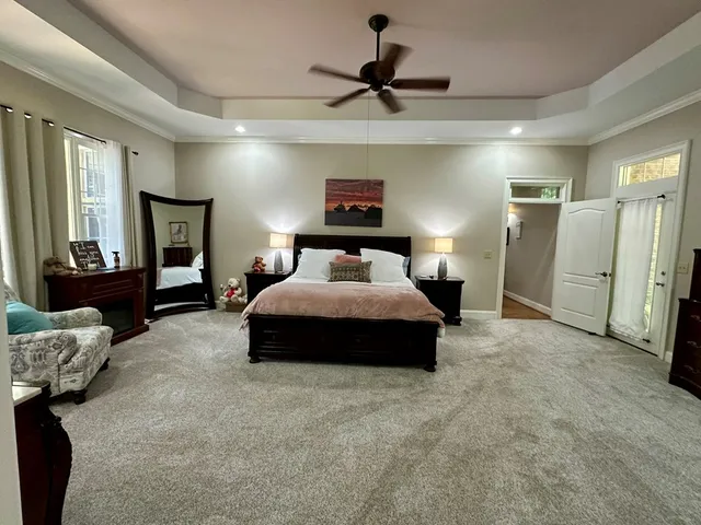 a spacious bedroom with a bed and a television