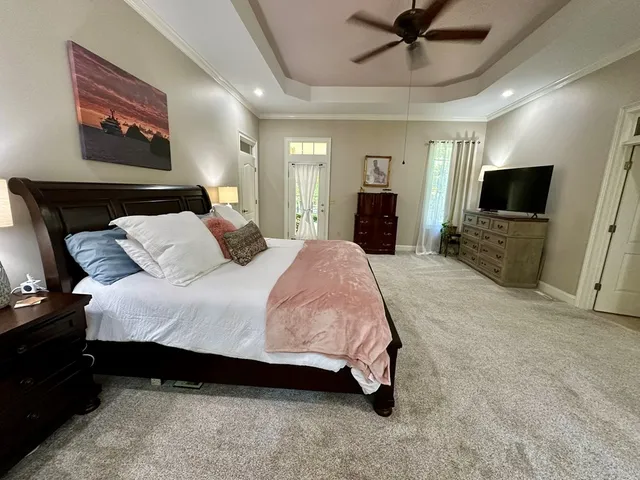 a living room with patio furniture and a potted plants