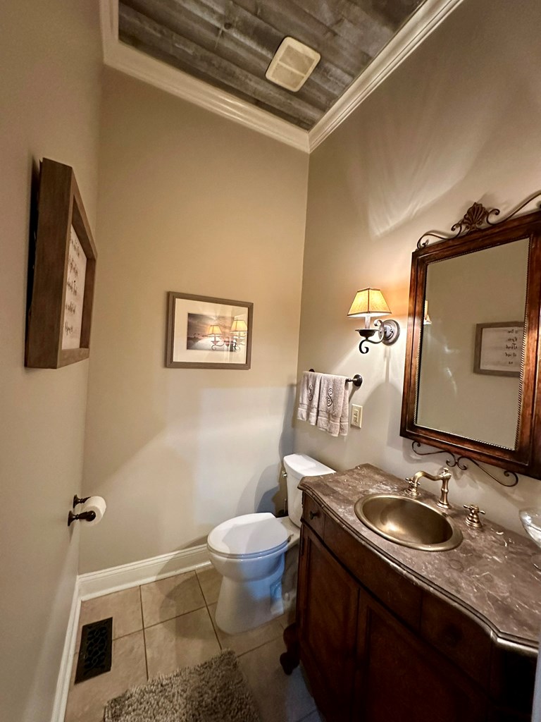 105 Lakeview Drive Hamilton, GA 31811 - Photo 34 of 63 a bathroom with a granite countertop sink mirror vanity and toilet