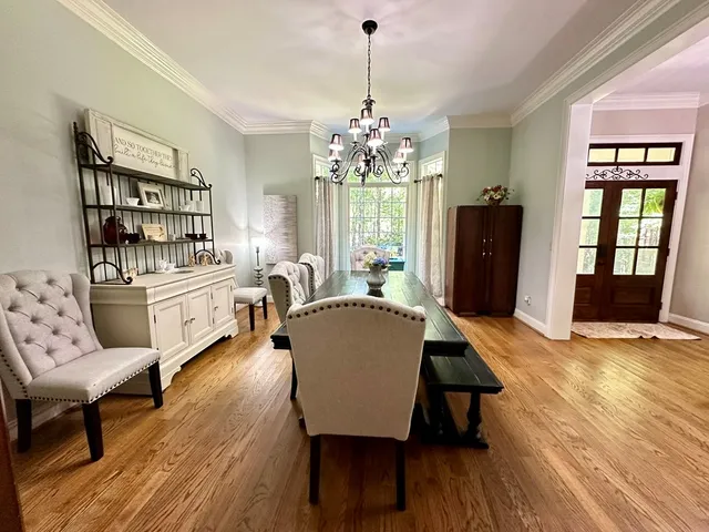 a view of a a dining room with furniture and wooden floor