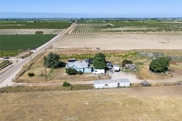 an aerial view of a house with a yard and lake view