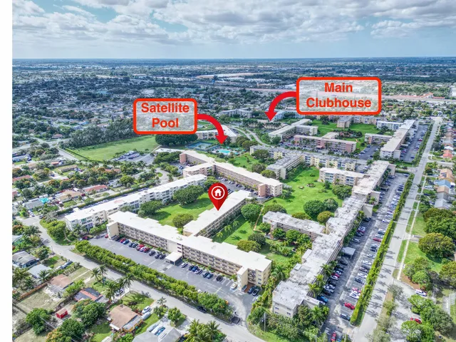 an aerial view of residential houses with outdoor space and trees all around