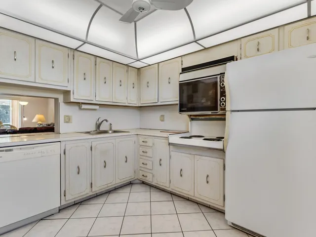 a kitchen with granite countertop cabinets stainless steel appliances and a sink