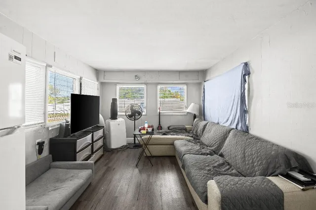 a living room with a bed furniture and a window