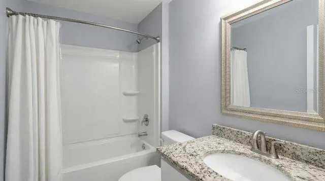 a view of backyard with swimming pool and outdoor seating