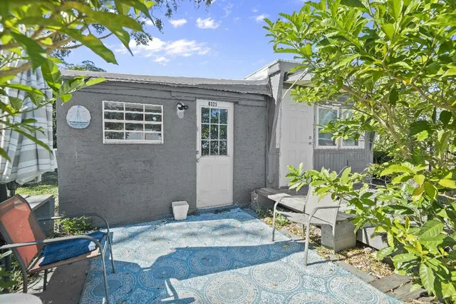a backyard of a house with outdoor seating